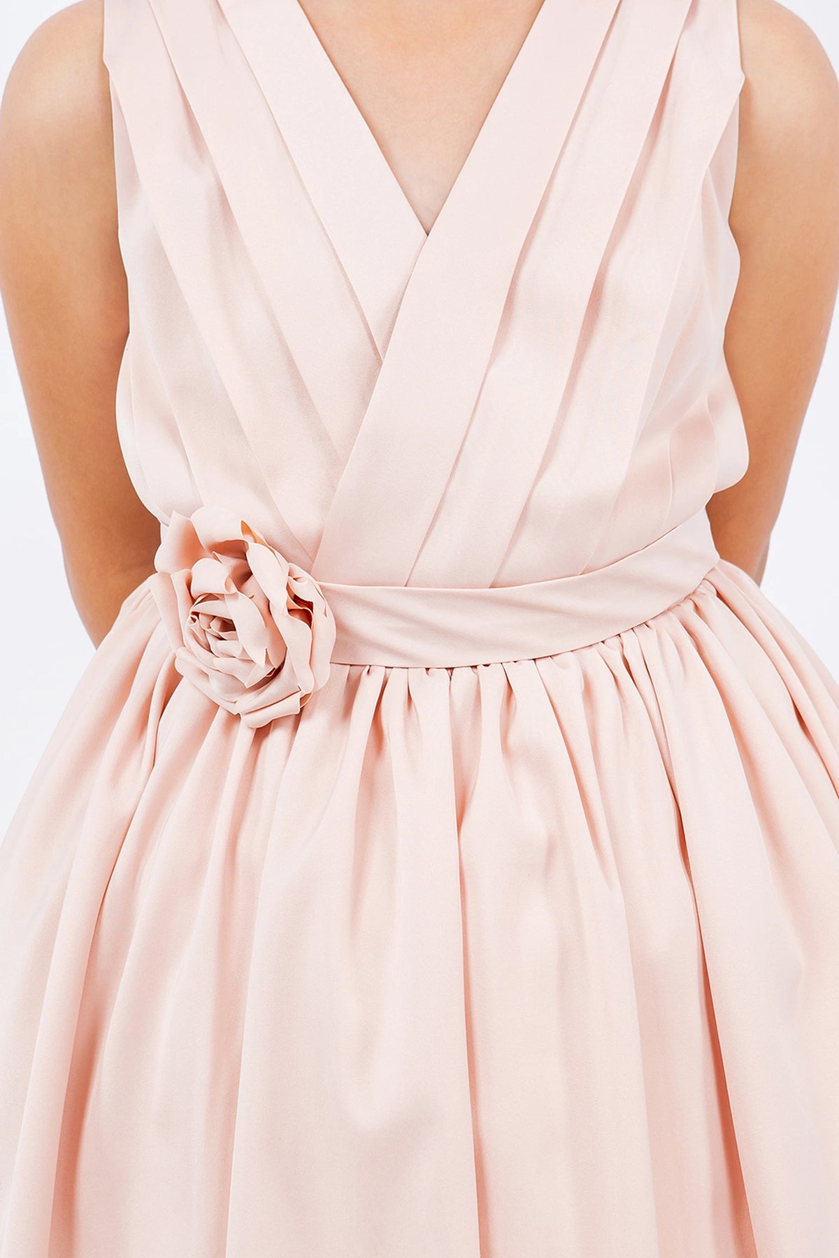 Detailed by a rosette at the waist, the Blush kids party dress reveals its construction.