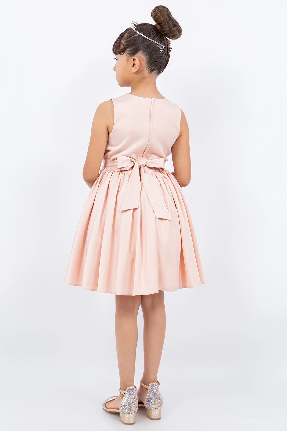 Finished details of a tied waist sash distinguish the Blush kids party dress.