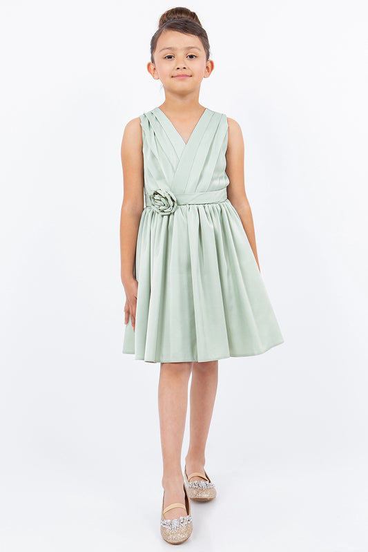 Showcasing with a rosette at the waist, this Sage kids party dress displays elegant detail.