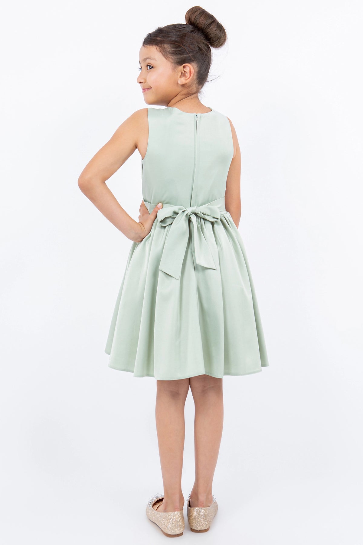 Finished details of a tied waist sash distinguish the Sage kids party dress.