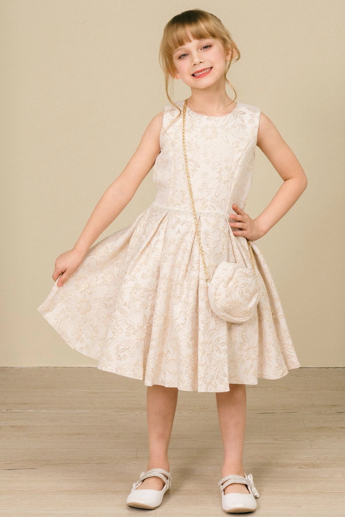 Showcasing with floral jacquard texture, this Champagne kids party dress displays elegant detail.