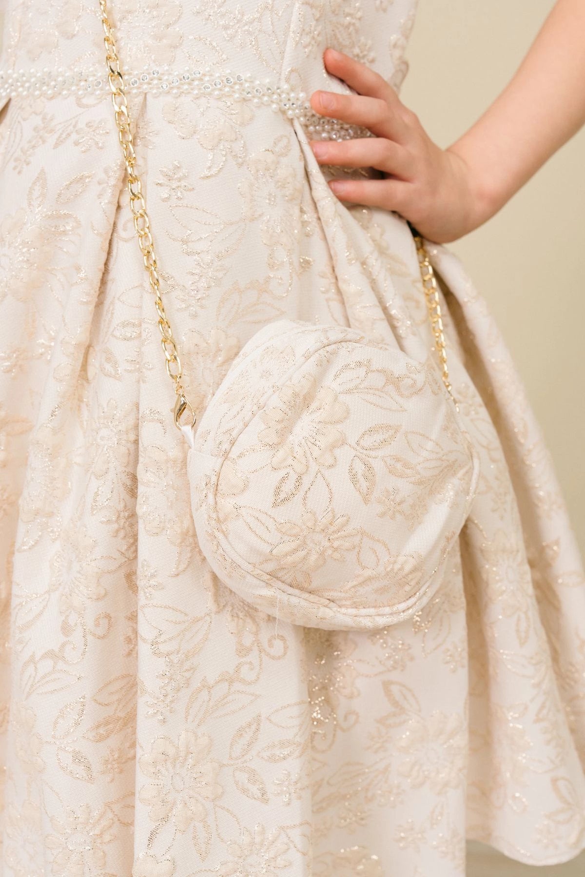 Accented floral jacquard texture adds character to this Champagne kids party dress.