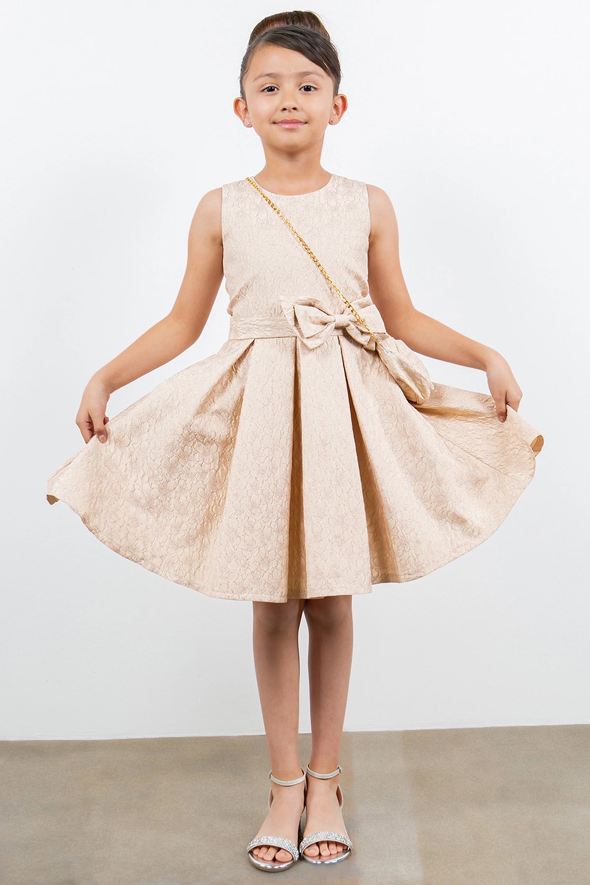 Showcasing with a large front waist bow, this Champagne kids party dress displays elegant detail.