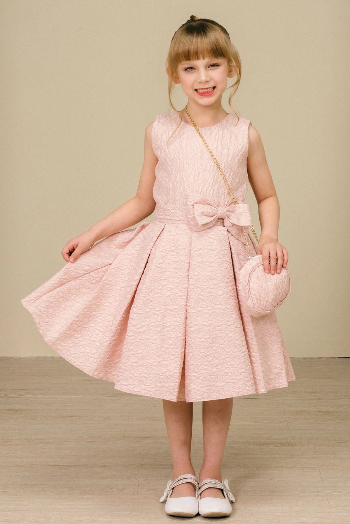 Showcasing with a large front waist bow, this Pink kids party dress displays elegant detail.