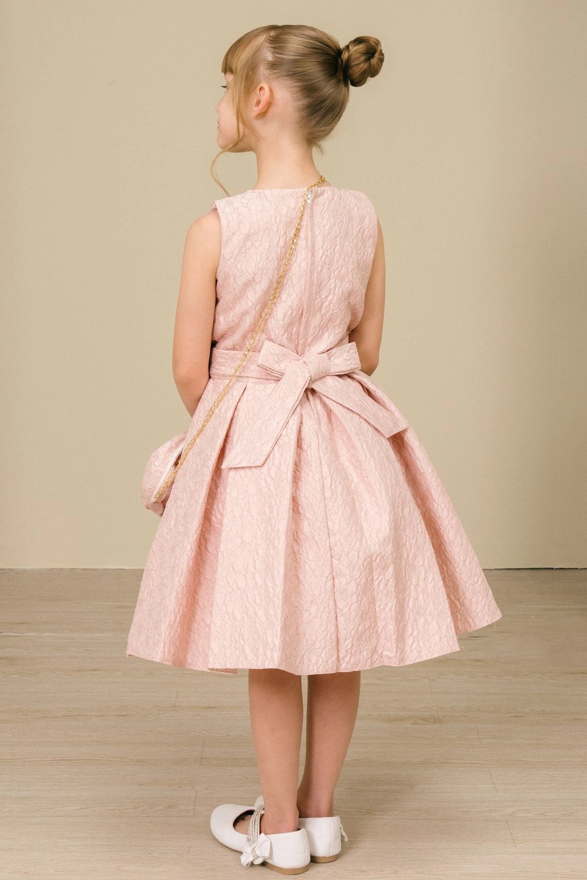 Finished details of a back bow distinguish the Pink kids party dress.