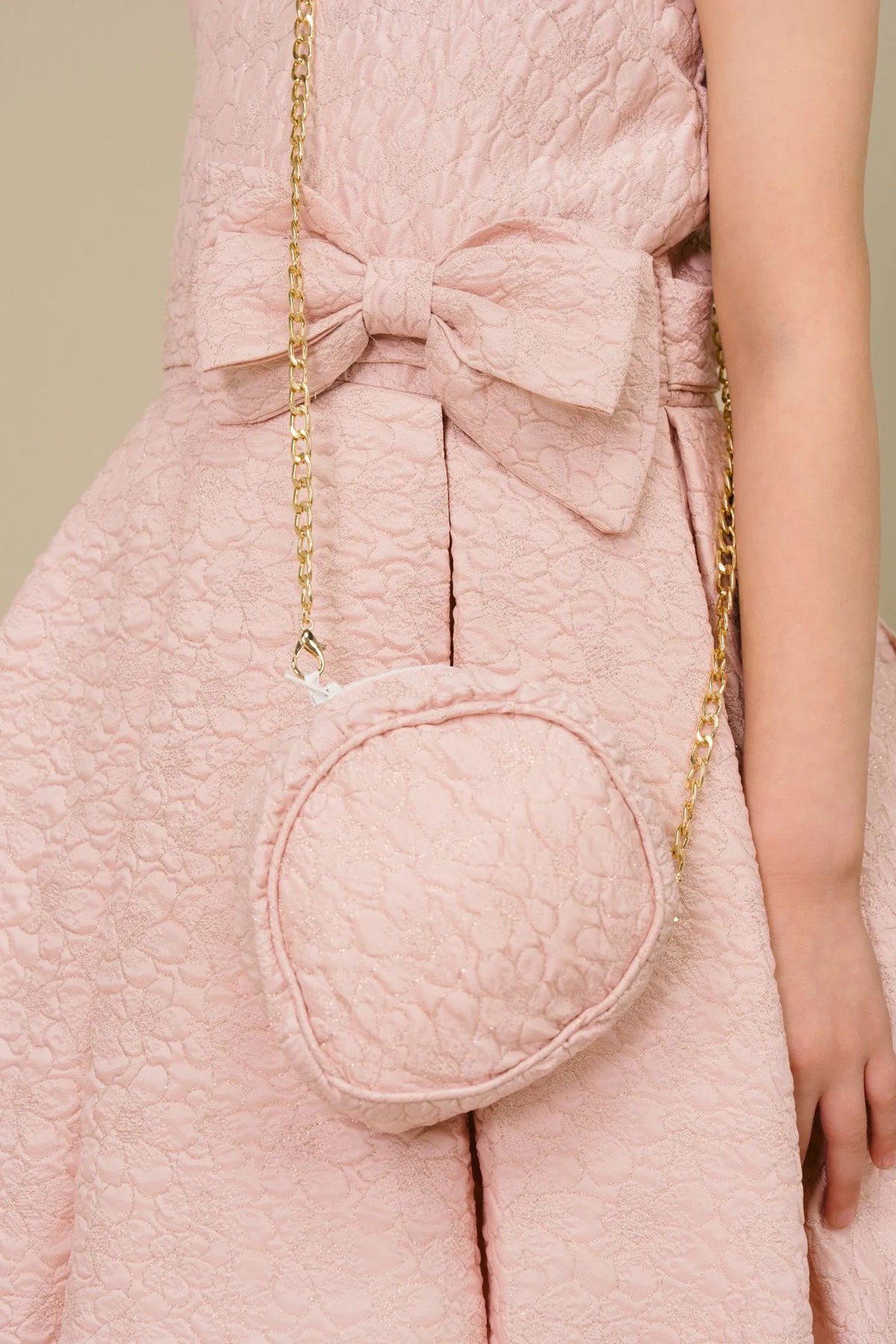 Detailed by a large front waist bow, the Pink kids party dress reveals its construction.