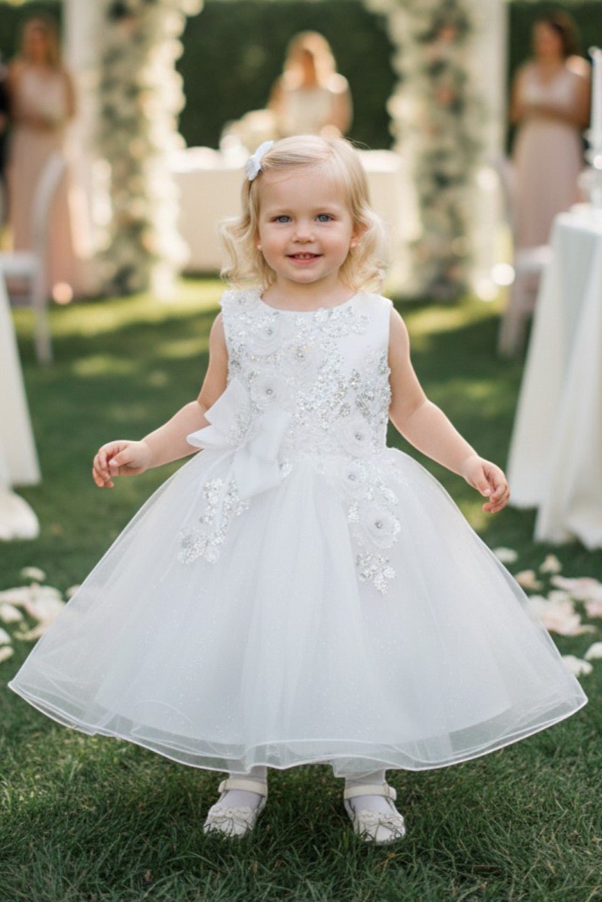 Kid Wearing White Flower Girl Dress Front View With Layered Skirt And Oversized Bow Detail
