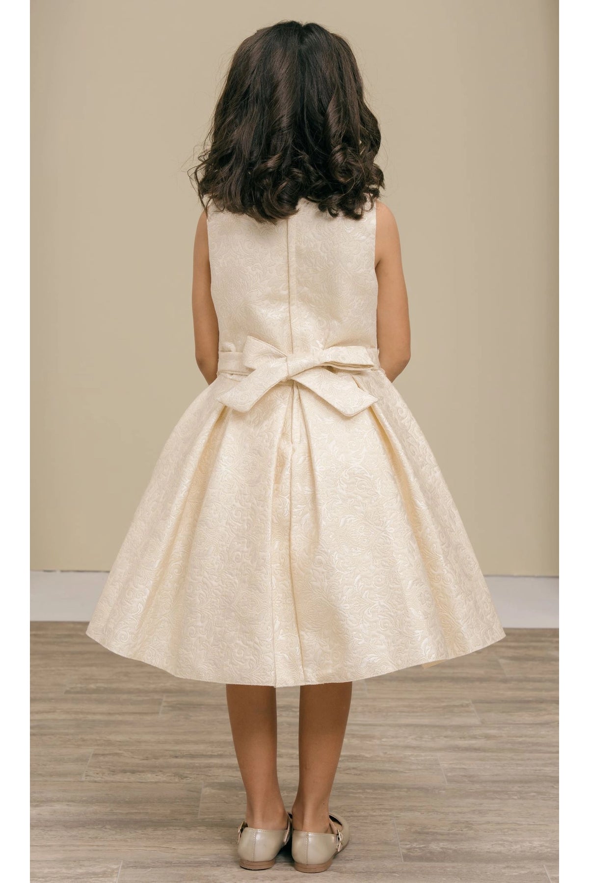 Finished details of a large waist bow distinguish the Ivory kids party dress.