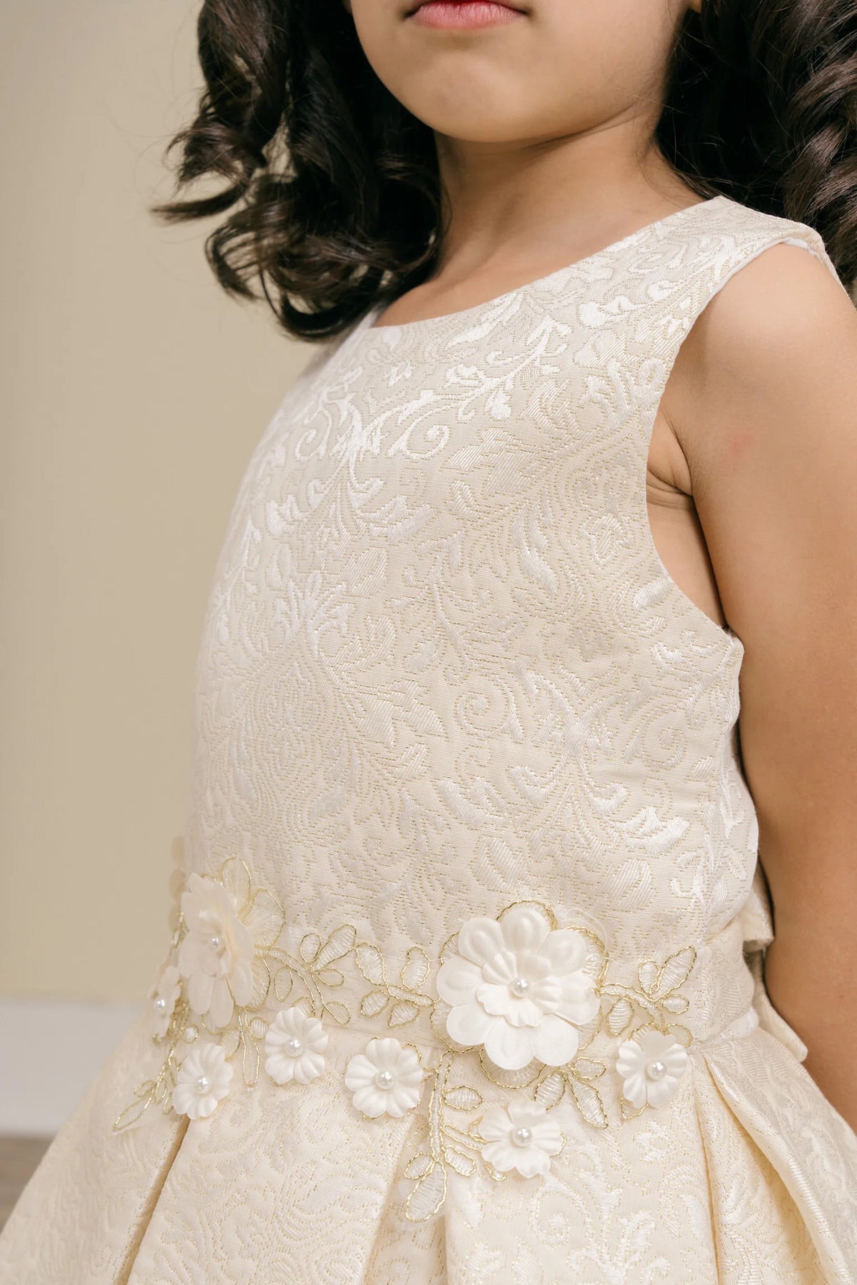 Accented flowers clustered along the waist adds character to this Ivory kids party dress.