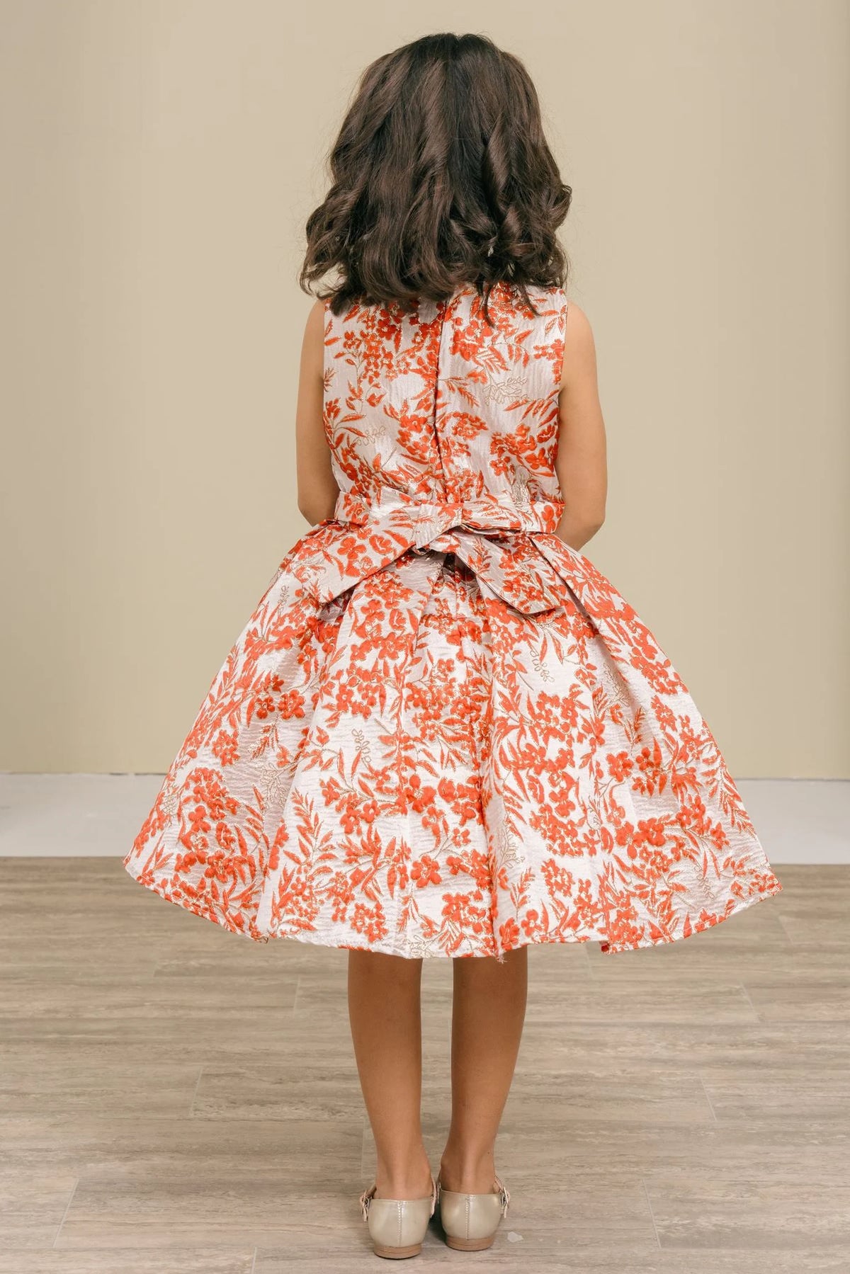 Finished details of a floral waist bow distinguish the Burgundy kids party dress.