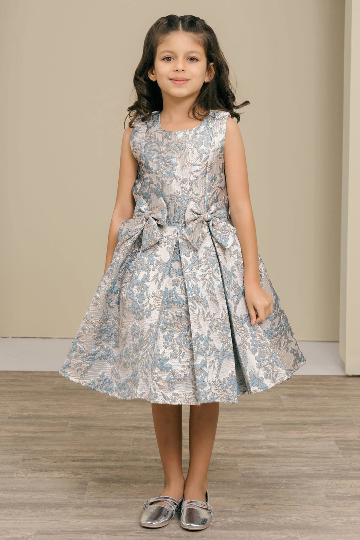 Showcasing with contrasting floral jacquard motifs, this Dusty Blue kids party dress displays elegant detail.