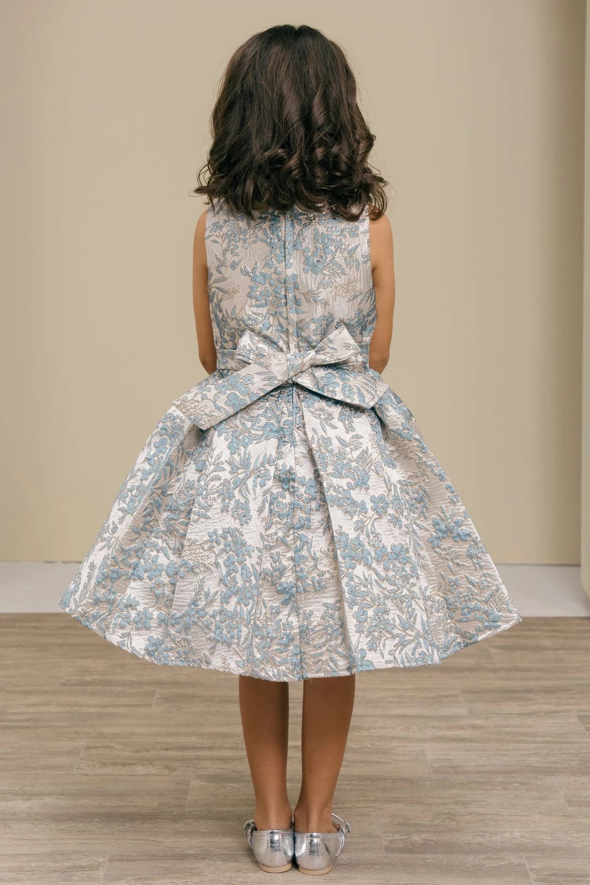 Finished details of a floral waist bow distinguish the Dusty Blue kids party dress.