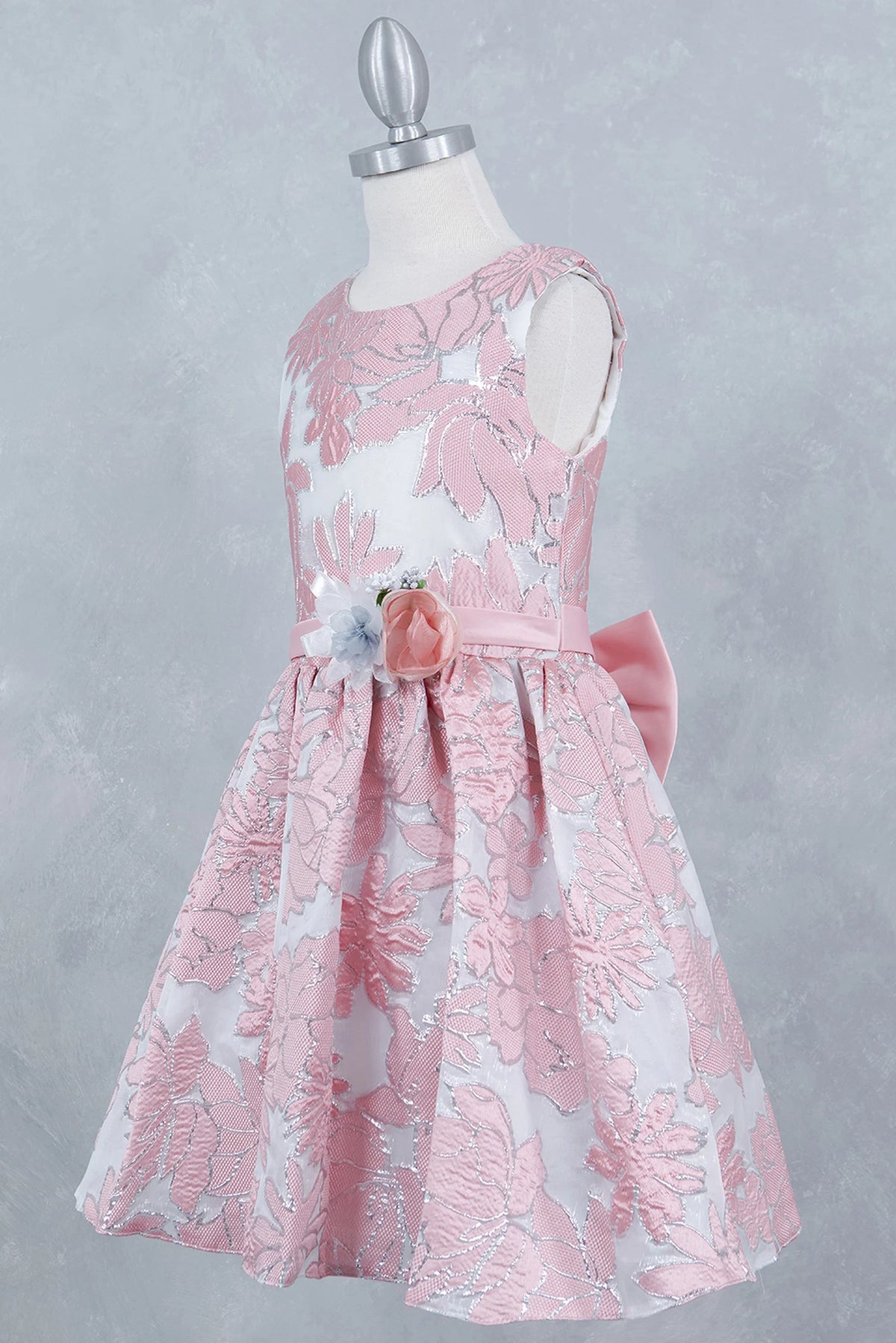 Showcasing with a decorative floral waist accent, this Pink kids party dress displays elegant detail.