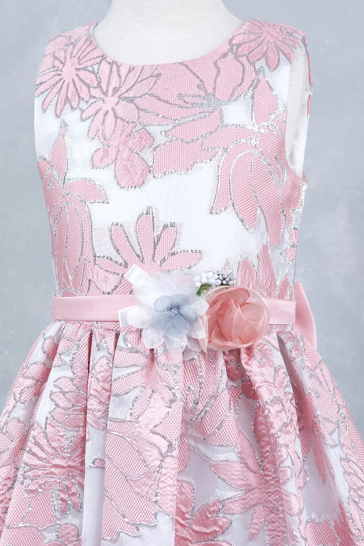 Featuring with a decorative floral waist accent, this Pink kids party dress displays elegant detail.