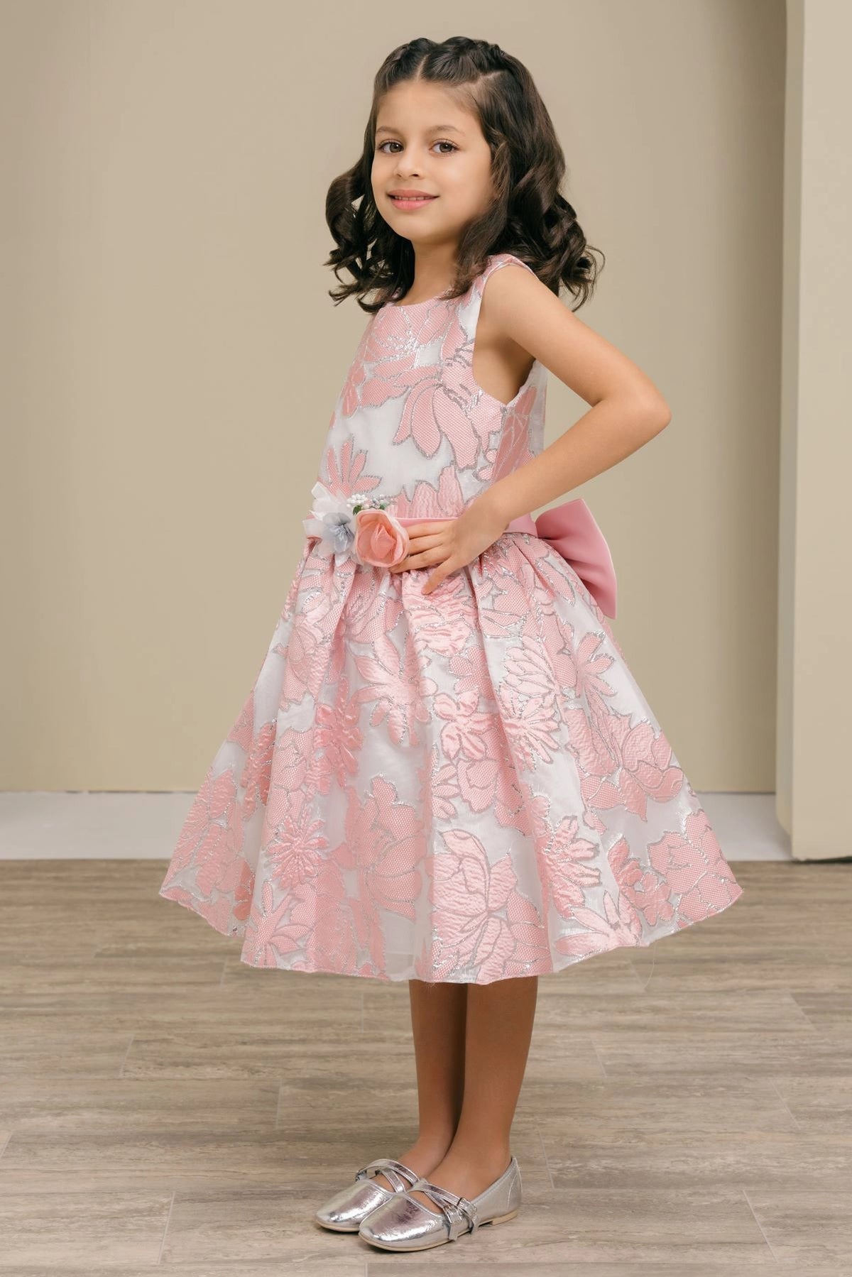 Highlighted a textured floral skirt adds character to this Pink kids party dress.