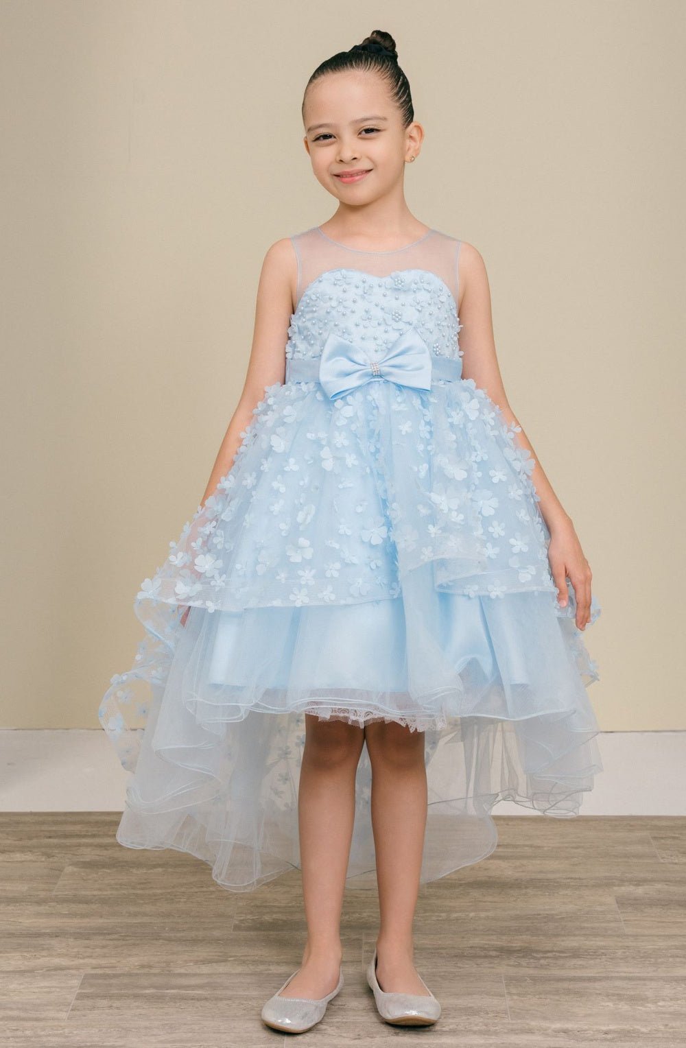 Blue flower girl dress front view with illusion bodice and hi-low 3D flower skirt.