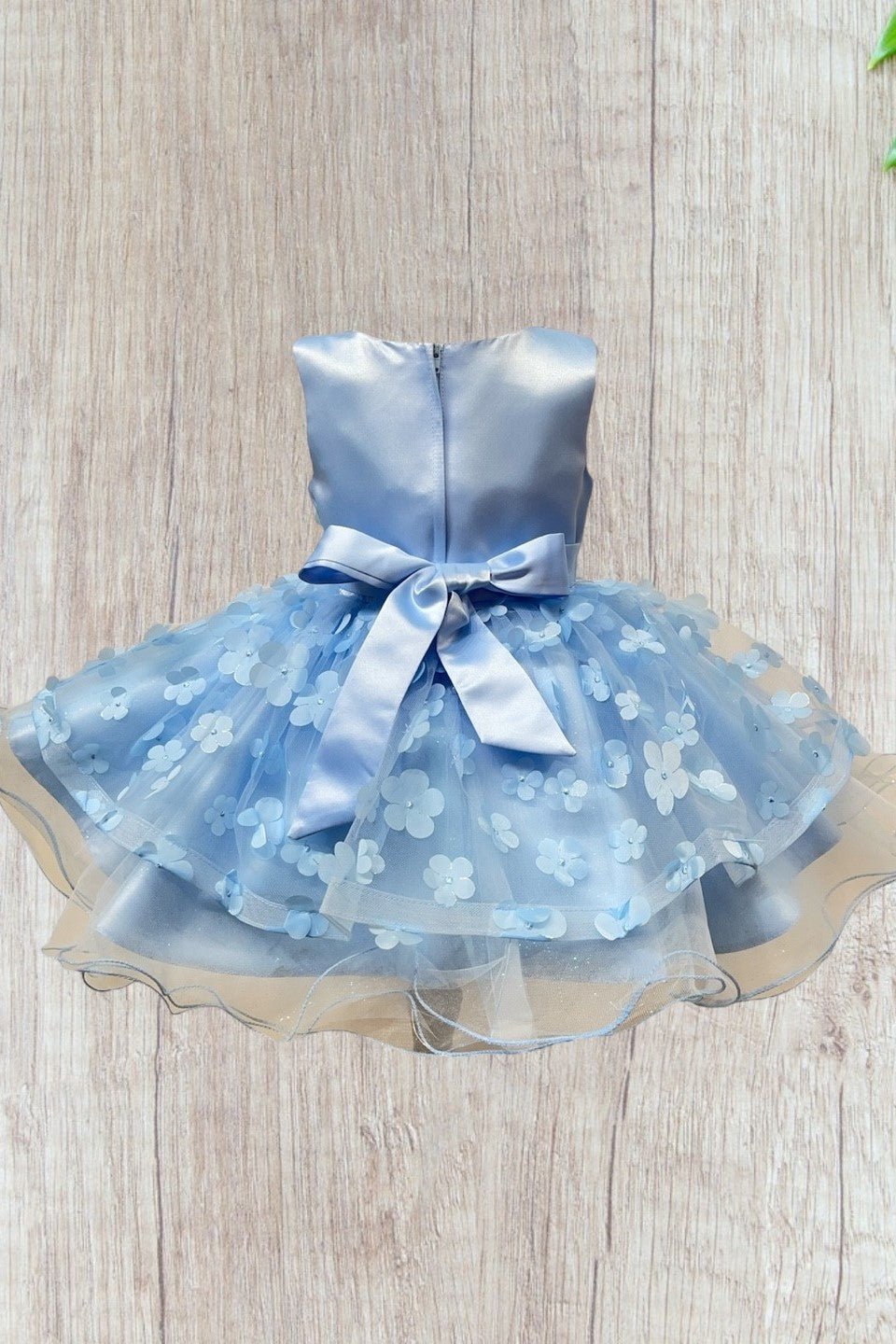 Blue flower girl dress back view highlighting elegant fit and classic silhouette.