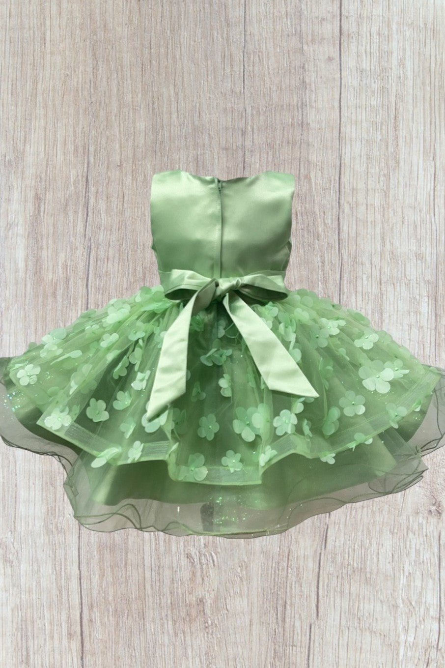Sage flower girl dress back view highlighting elegant fit and classic silhouette.