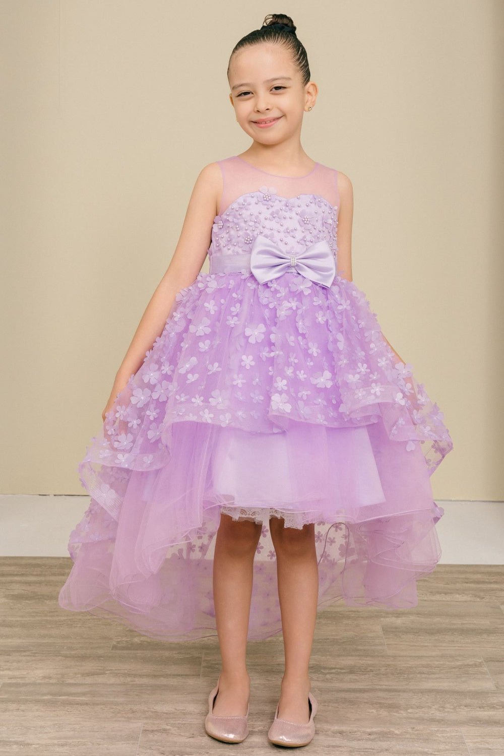 Lilac flower girl dress front view with illusion bodice and hi-low 3D flower skirt.