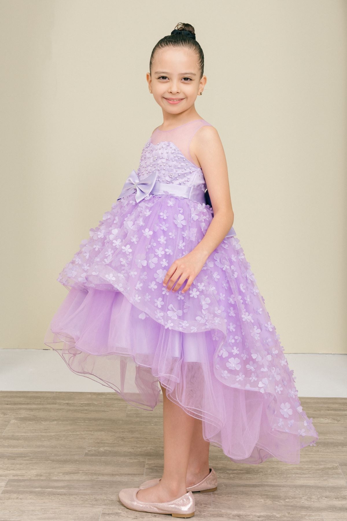 Lilac flower girl dress side view highlighting hi-low silhouette and elegant structure.