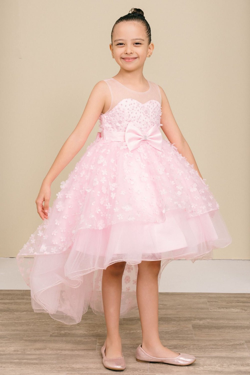 Pink flower girl dress front view with illusion bodice and hi-low 3D flower skirt.