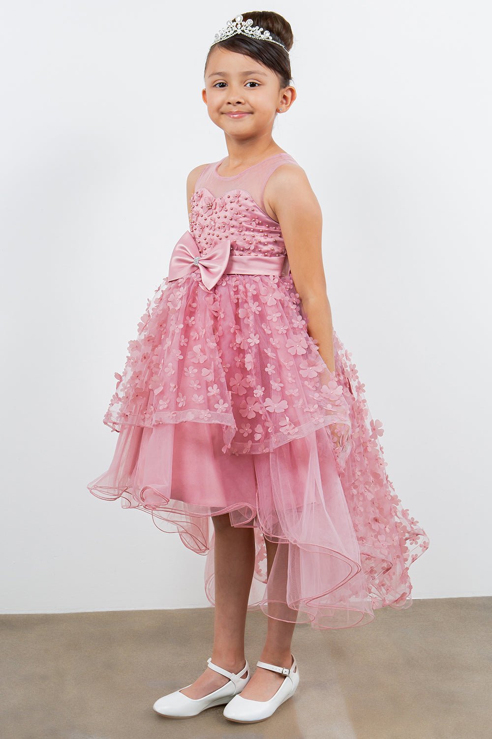 Dusty pink flower girl dress side view highlighting hi-low silhouette and elegant structure.