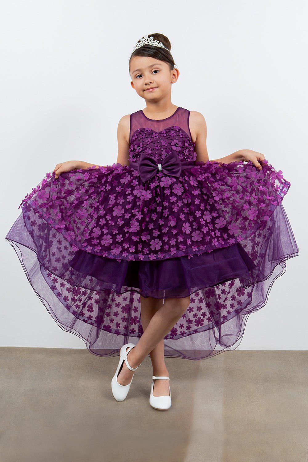 Purple flower girl dress side view highlighting hi-low silhouette and elegant structure.