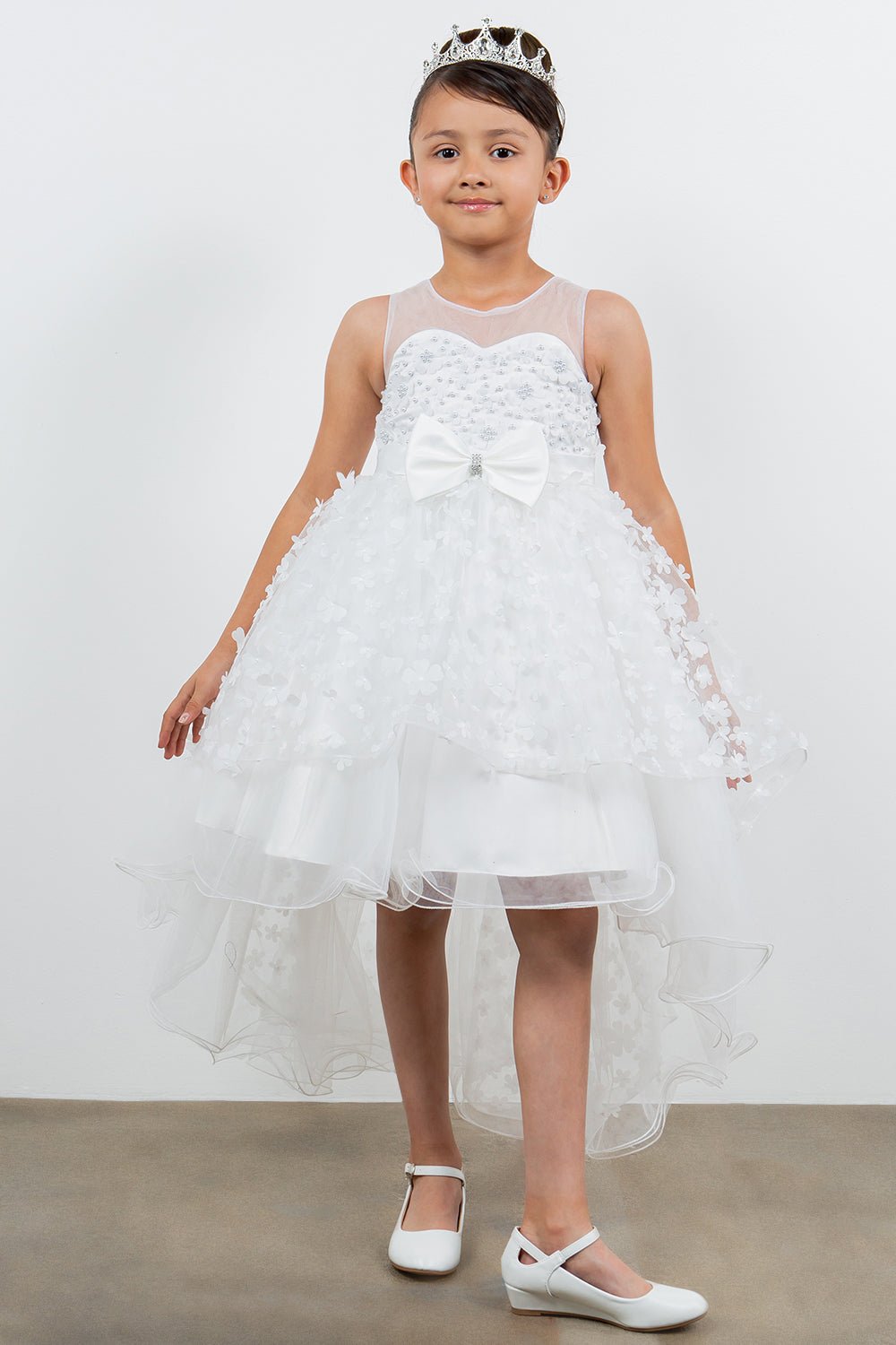 White flower girl dress front view with illusion bodice and hi-low 3D flower skirt.