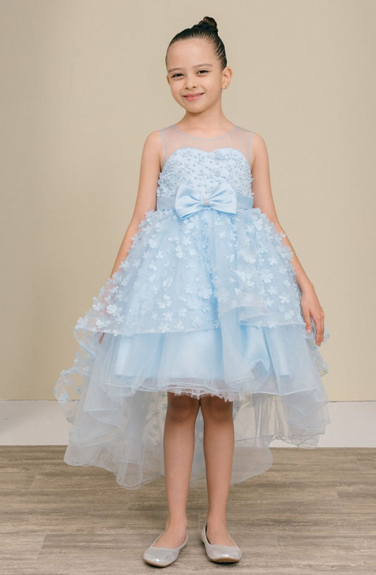 Kid wearing Blue flower girl dress front view with illusion bodice and hi-low 3D flower skirt