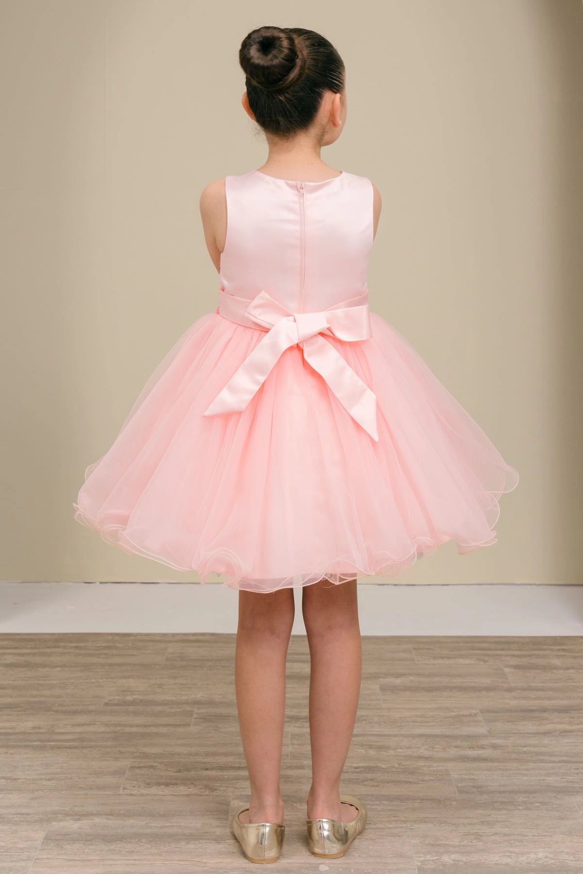 Showcasing with a satin waist bow, this Blush kids party dress displays elegant detail.