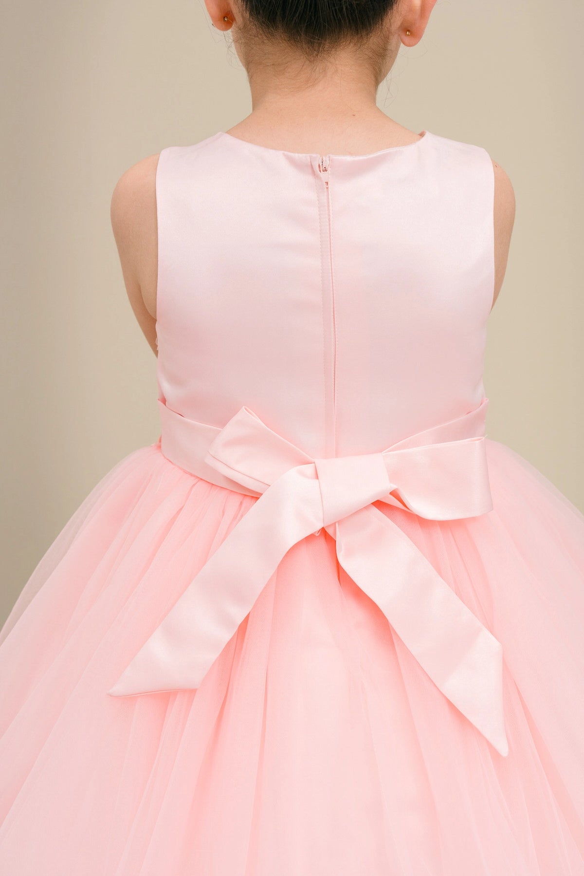 Finished details of a satin waist bow distinguish the Blush kids party dress.