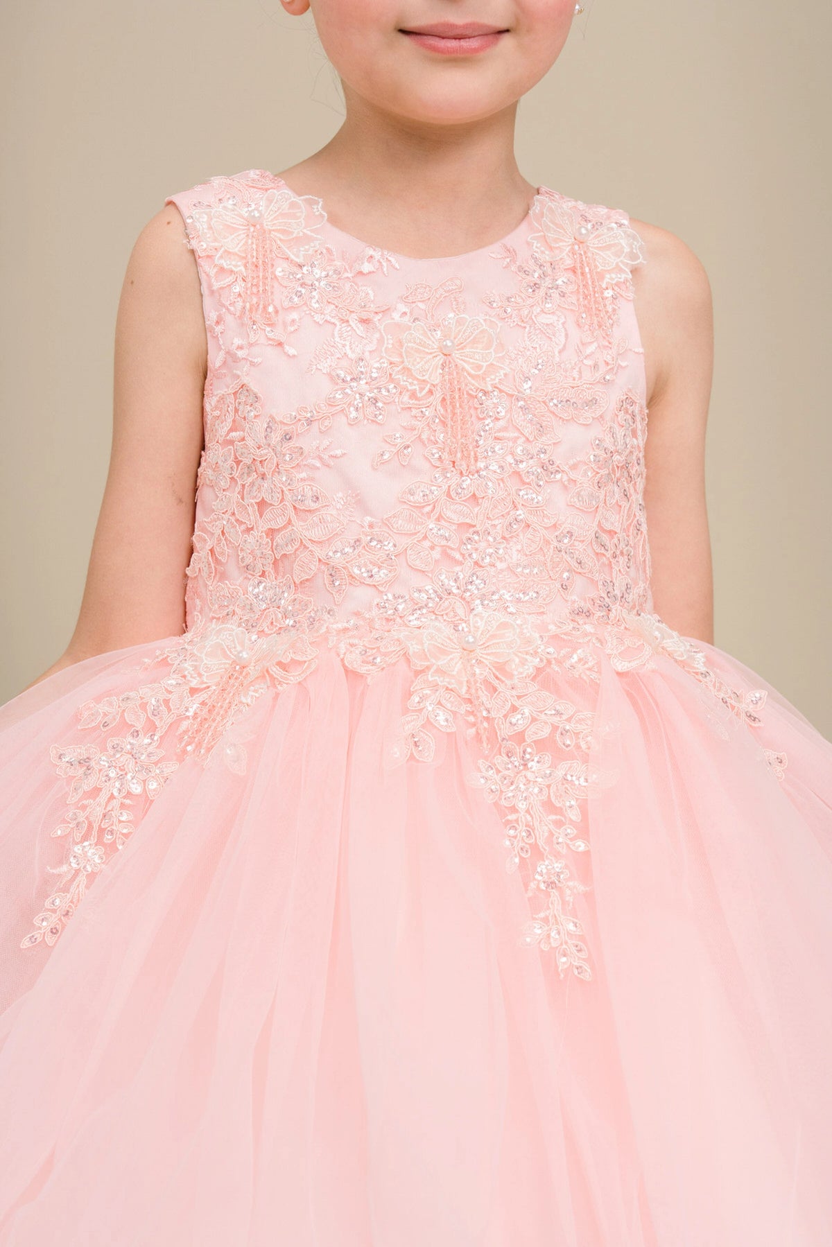 Detailed by floral lace across the bodice, the Blush kids party dress reveals its construction.