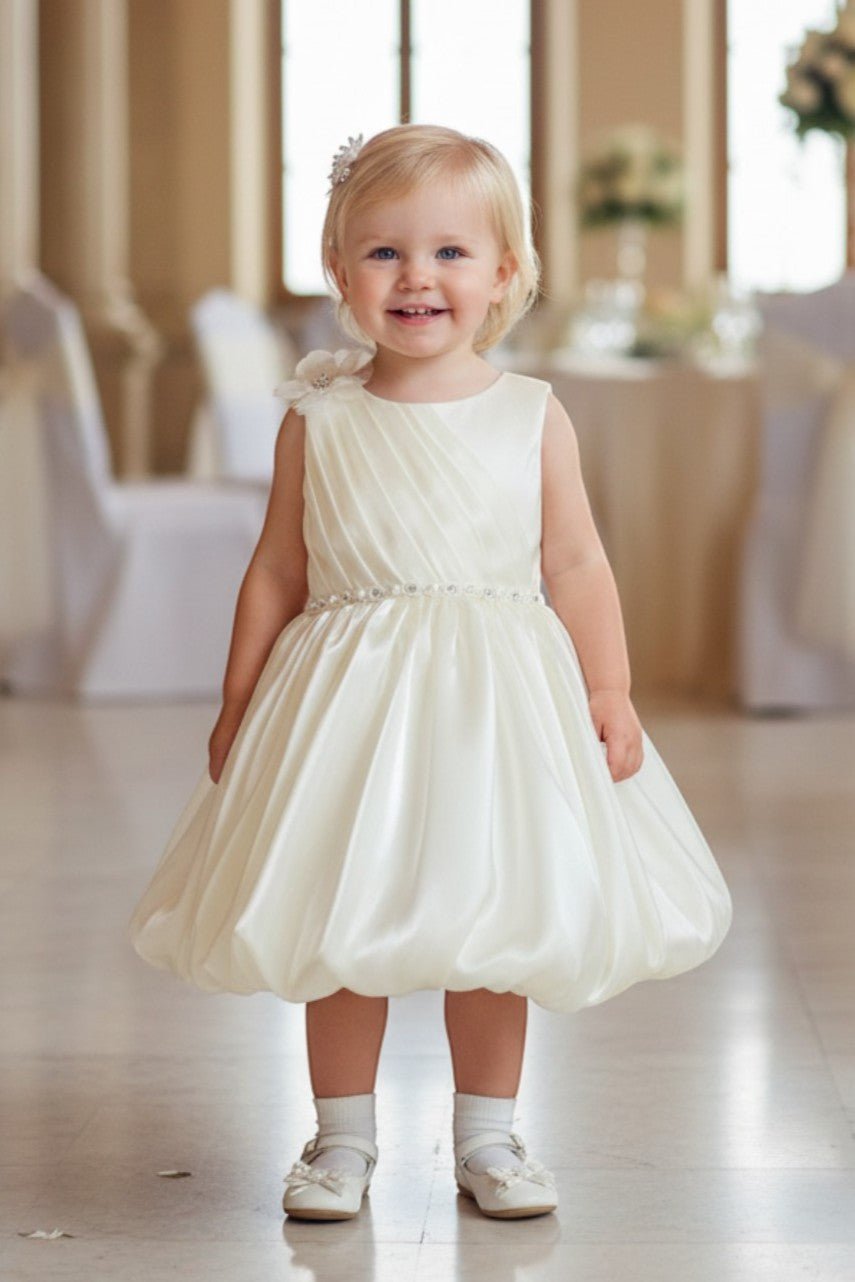 Ivory flower girl Dress Front View With Pleated Bodice And Floral Shoulder Detail.