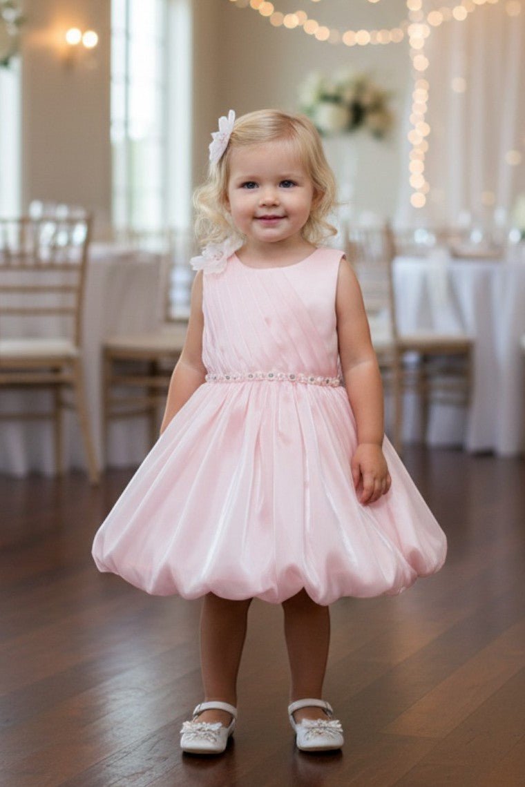 Peach flower girl Dress Front View With Pleated Bodice And Floral Shoulder Detail.
