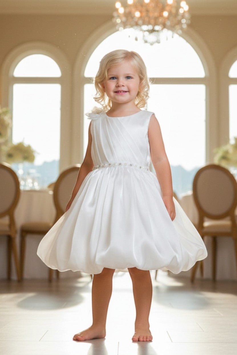 White flower girl Dress Front View With Pleated Bodice And Floral Shoulder Detail.
