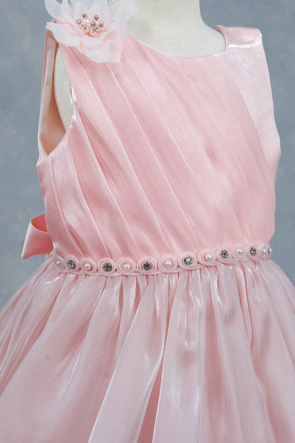 Close-up front view of peach dress showing beadwork floral applique and pearl waist