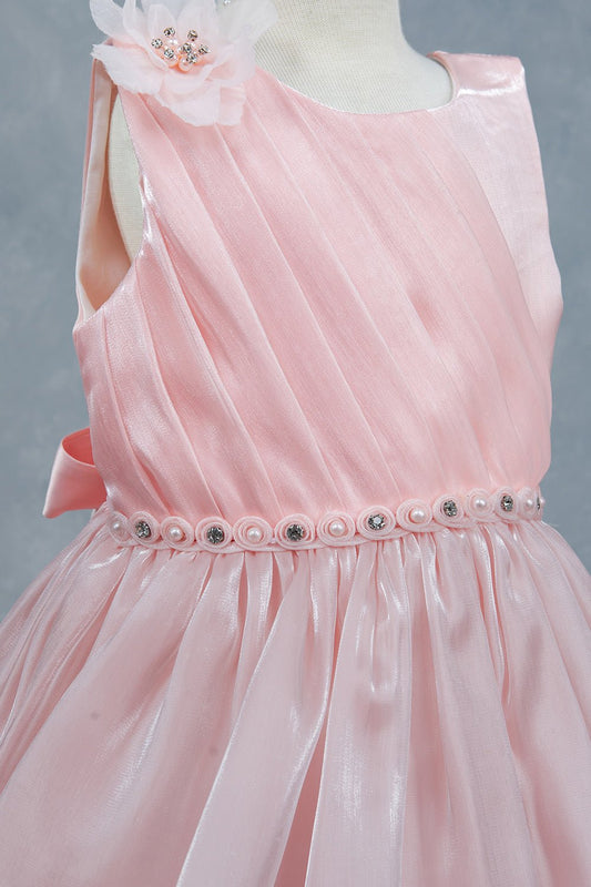 Close-up front view of peach dress showing beadwork floral applique and pearl waist