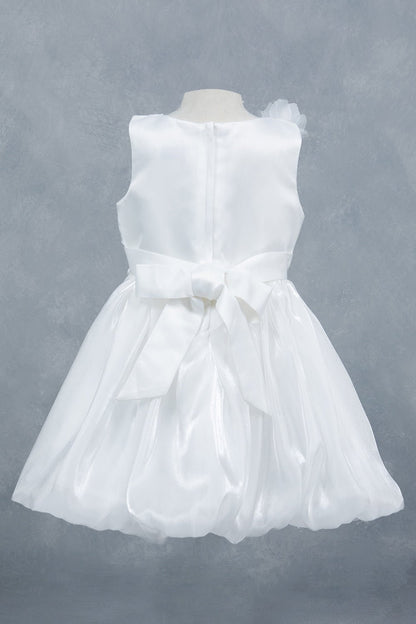 White dress back view highlighting elegant silhouette and soft layered design