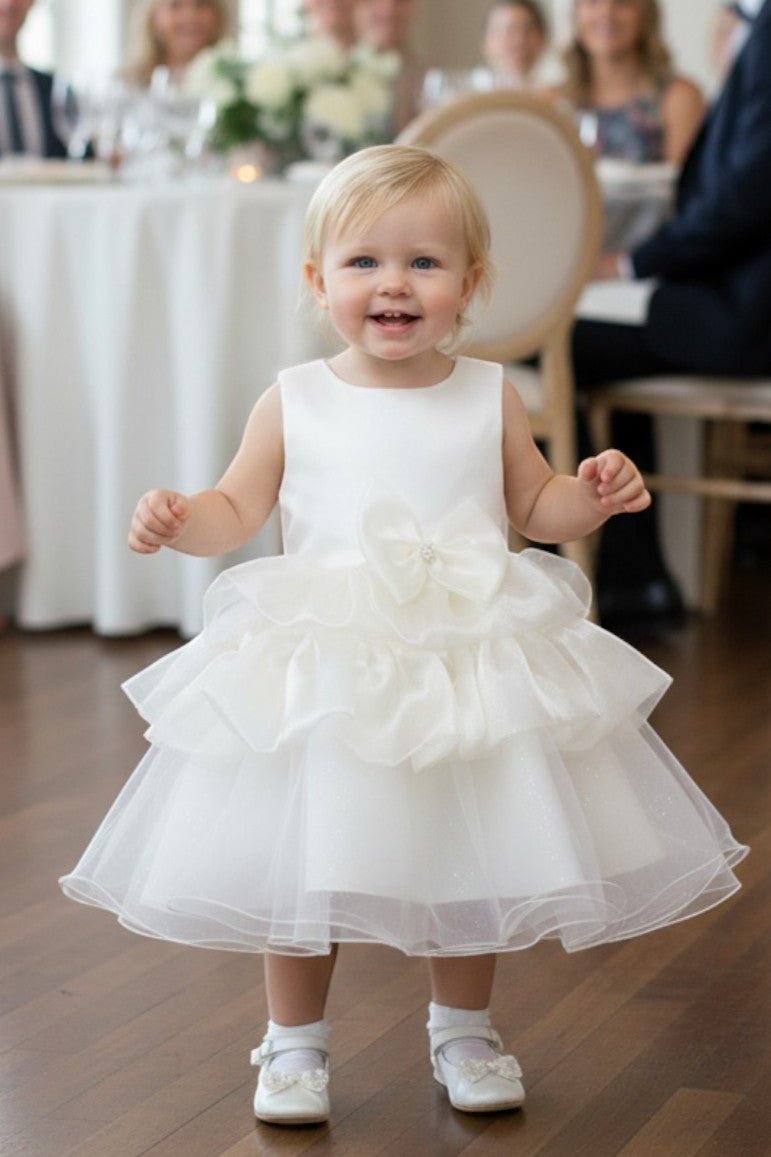 Ivory flower girl Dress Front View With Floral Waist Detail And Layered Tulle Skirt.