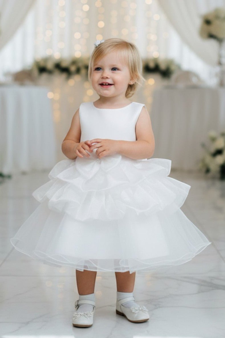 White flower girl Dress Front View With Floral Waist Detail And Layered Tulle Skirt.
