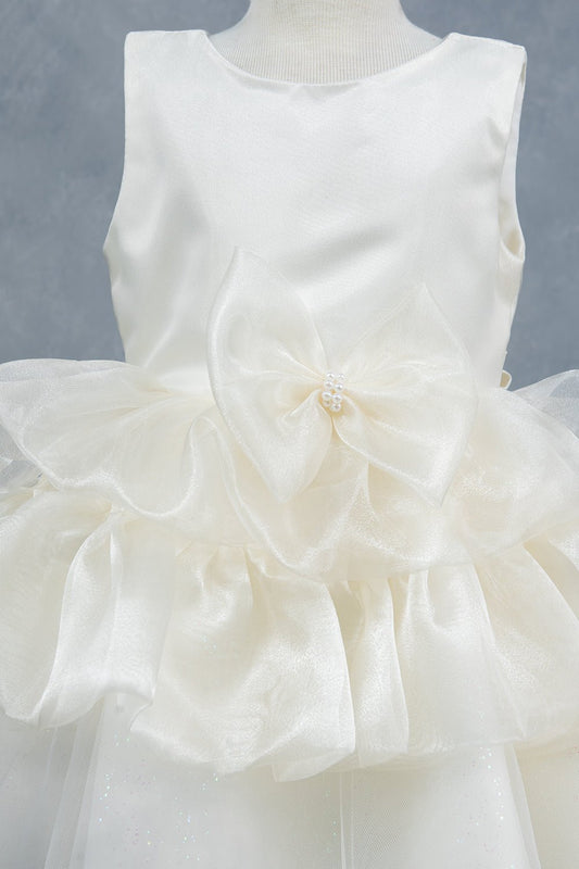 Close-up front view of white dress showing floral embellishment and satin waistband