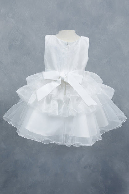 White dress back view highlighting layered tulle and soft silhouette