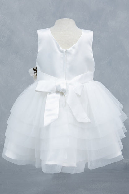 White dress back view highlighting layered tulle and soft silhouette
