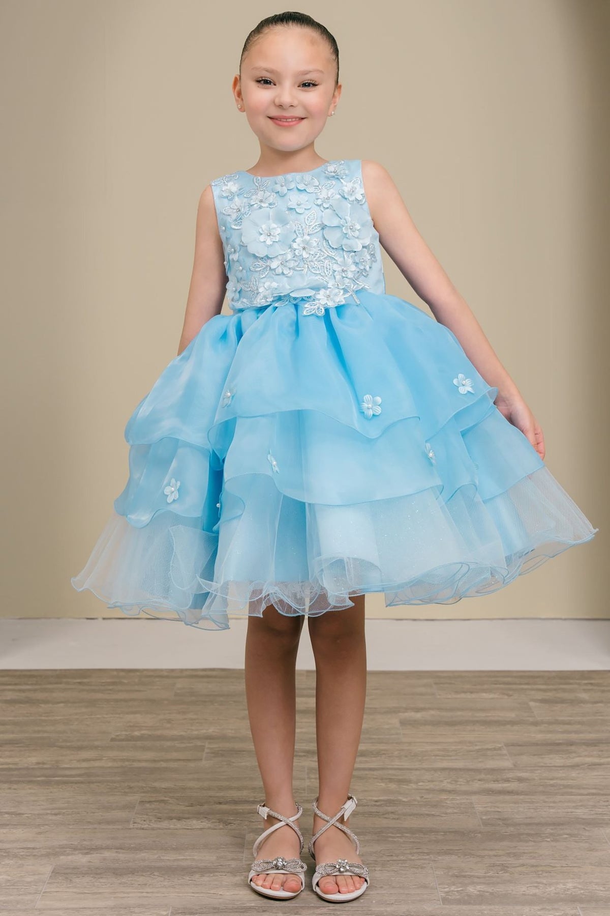A light blue flower girl dress with floral details.