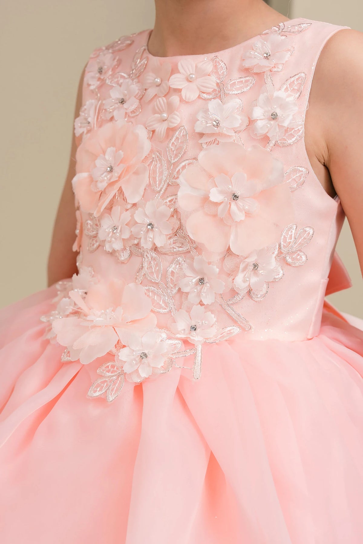 Peach blush flower girl dress with floral embellishments.