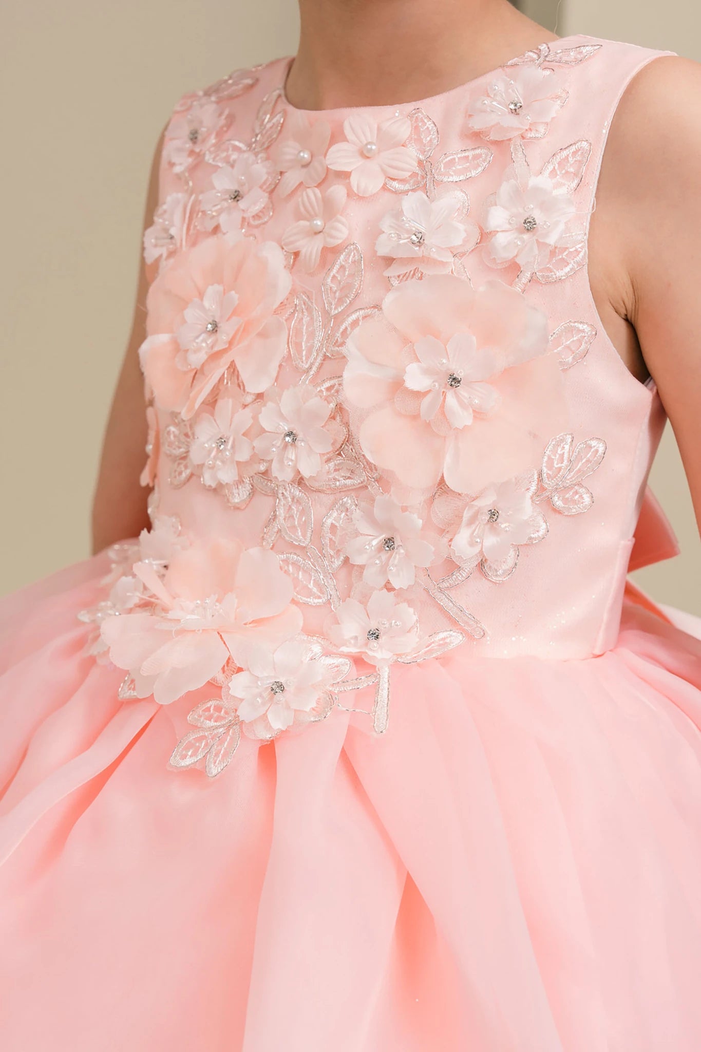 peach blush dress with floral embellishments on a plain background