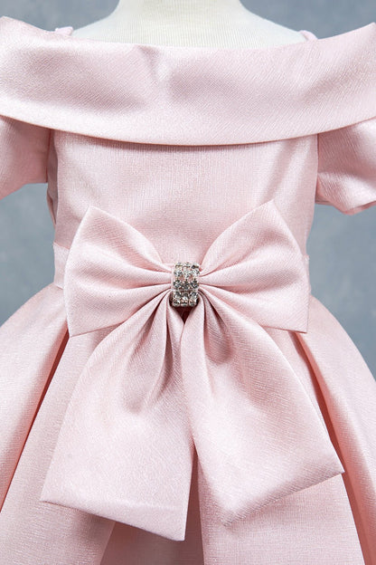 Close-up front view of blush dress showing rhinestone bow detail and collar