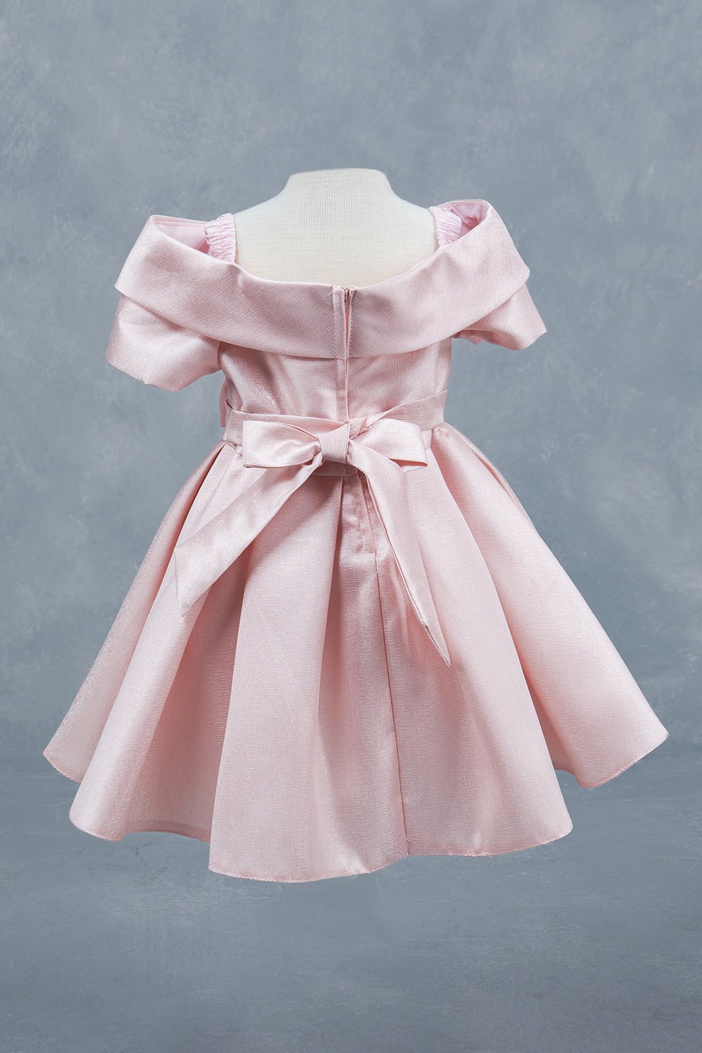 Blush dress back view highlighting elegant fit and classic silhouette