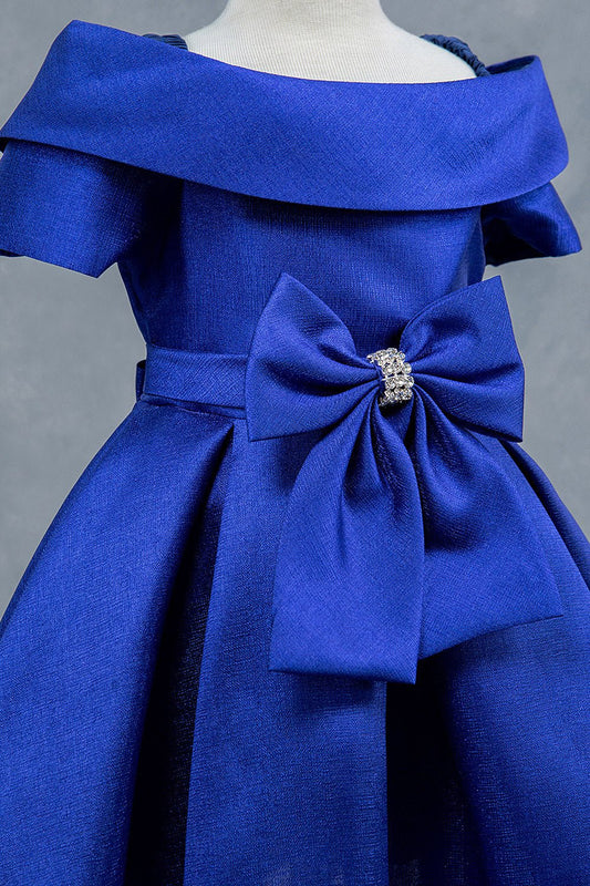 Close-up front view of blue dress showing rhinestone bow detail and collar