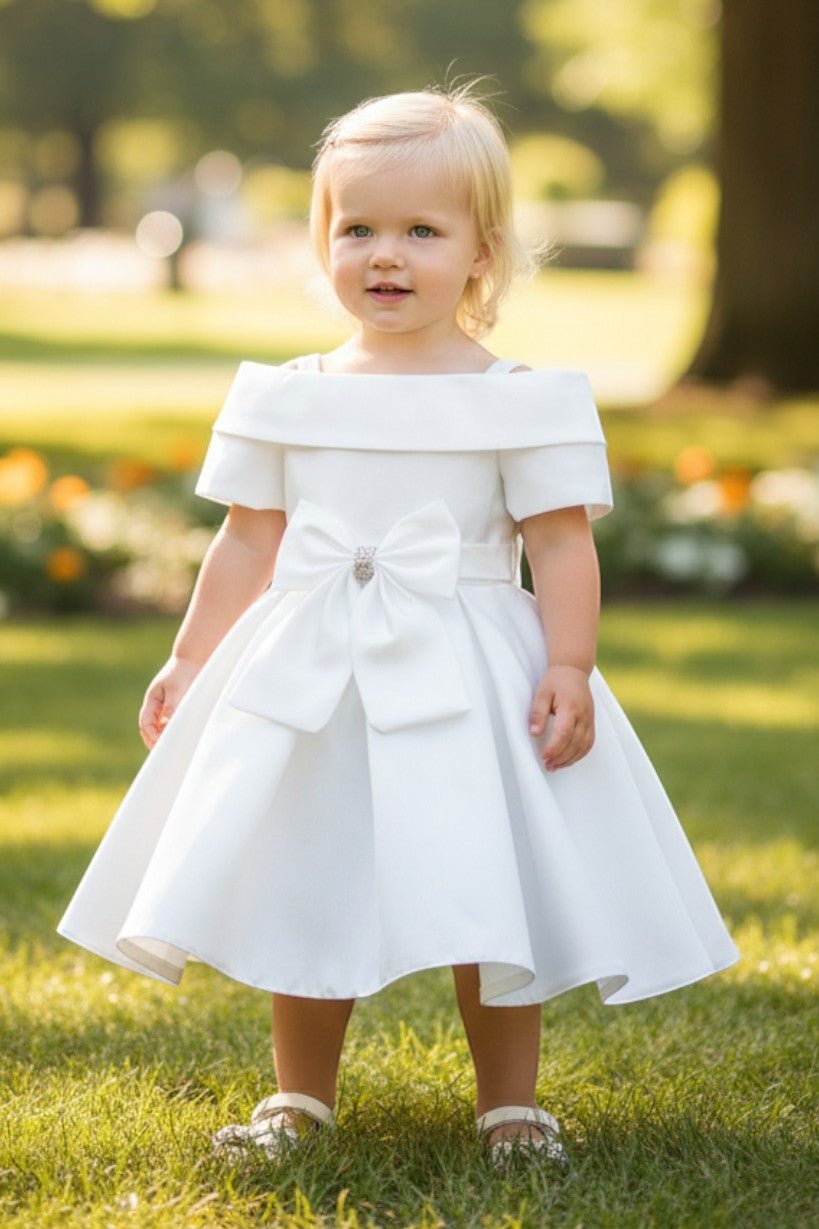 Kid Wearing White Flower Girl Dress Front View With Off Shoulder Neckline And Bow Waist